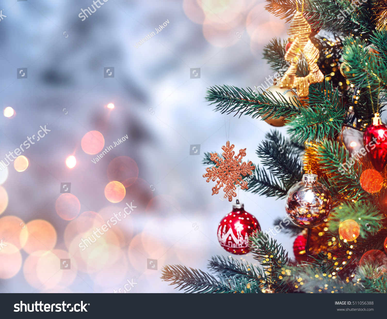 Christmas tree background and Christmas decorations with snow, blurred, sparking, glowing. Happy New Year and Xmas theme #511056388