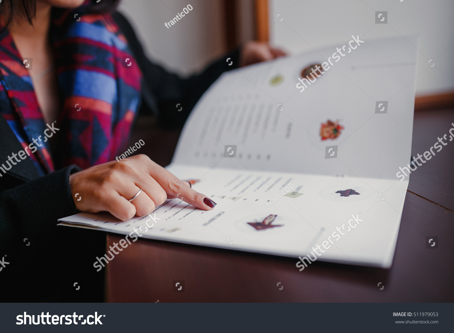 close up of woman finger with menu choosing dishes at restaurant #511979053
