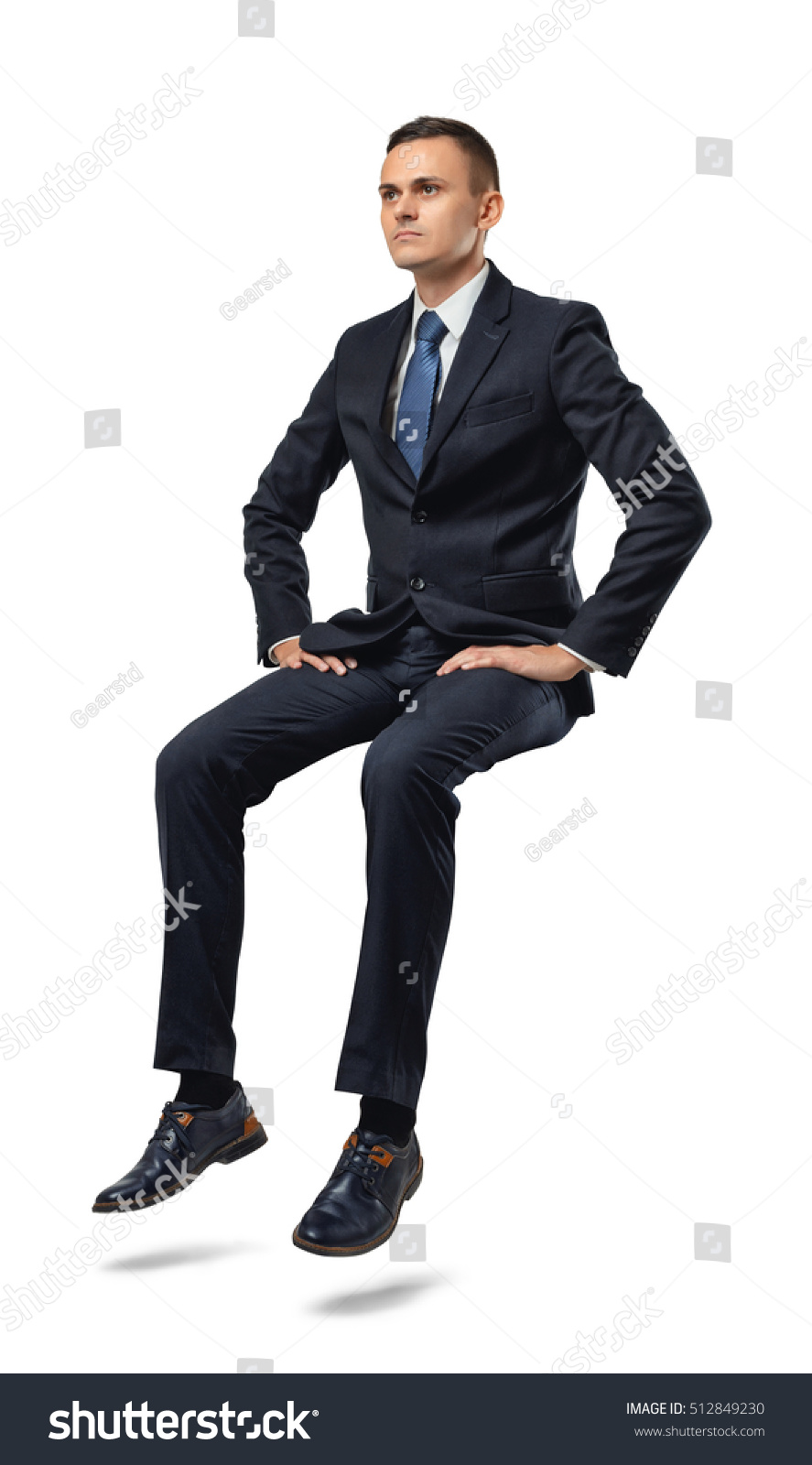 Cut-out full portrait of a businessman sitting on an invisible surface. Confident pose. Determination and perseverance. Confidence in the correctness of its decision. Reliable support. #512849230