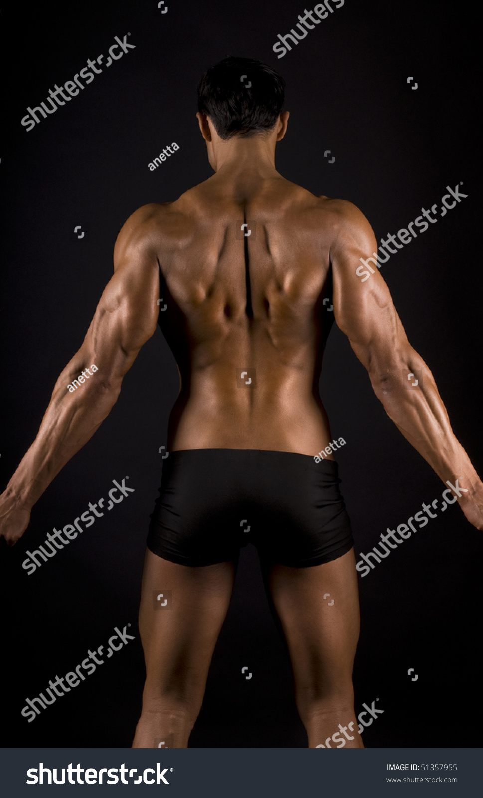 male muscular back on black background. #51357955