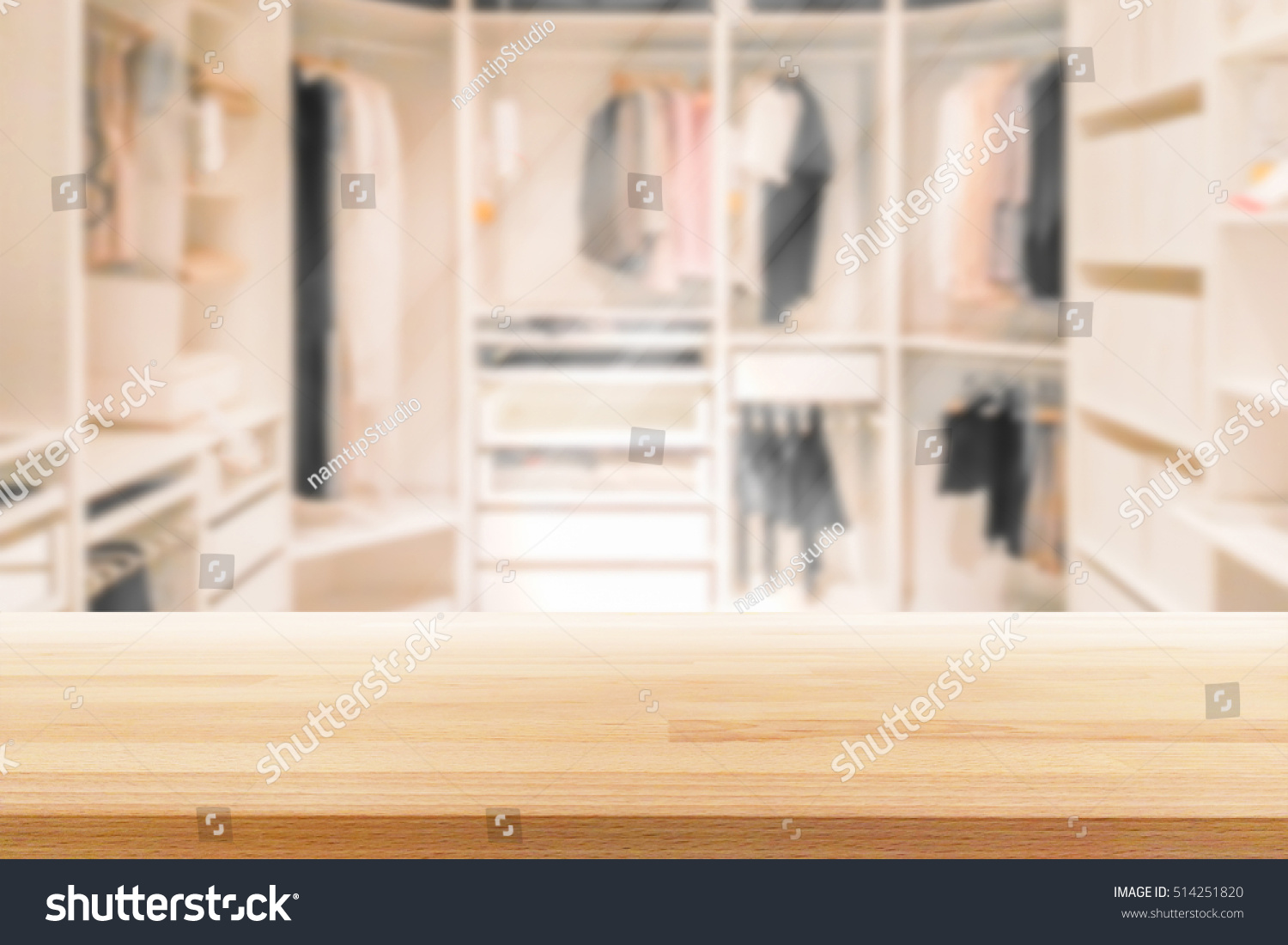 Empty wooden table on a background blur closet in the room  for display or montage your products #514251820