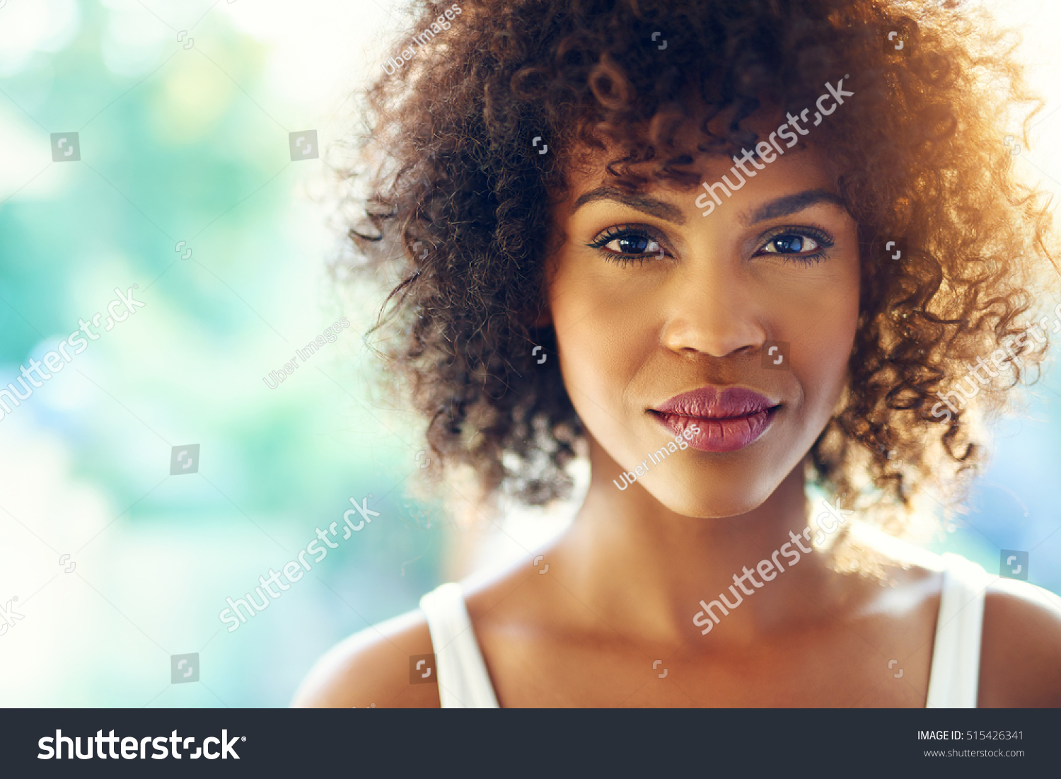 Close up portrait of beautiful curly girl looking at camera emotionless. Copyspace #515426341