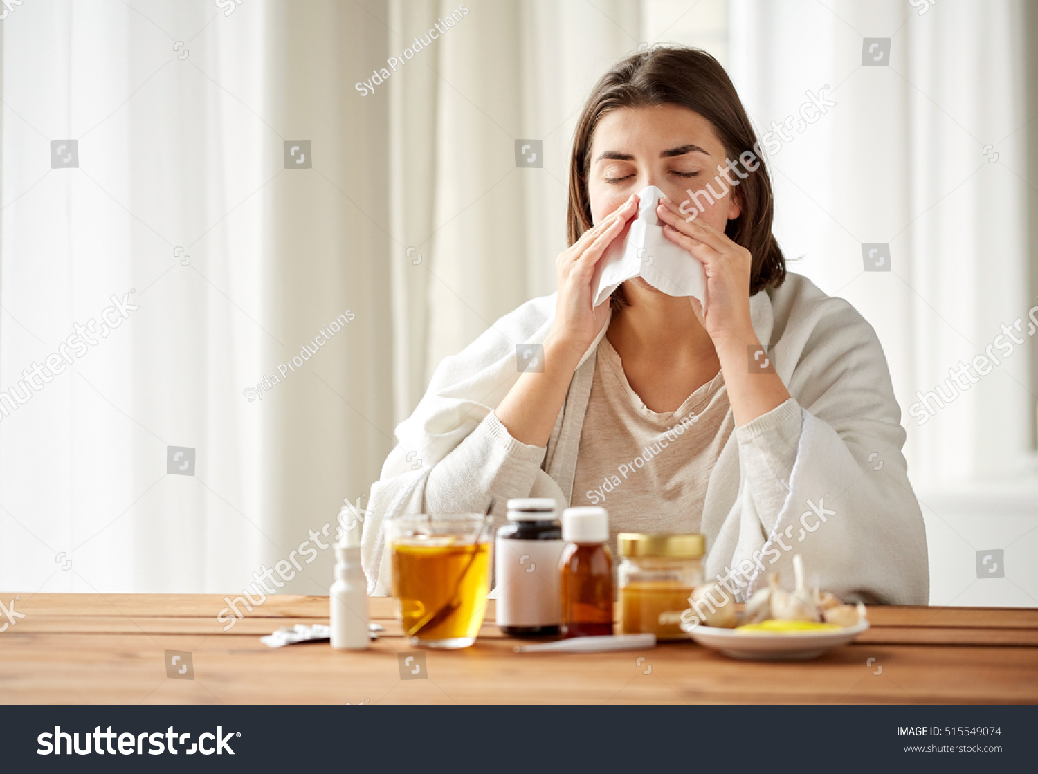 health care, flu, hygiene, age and people concept - sick woman with medicine blowing nose to paper wipe at home #515549074