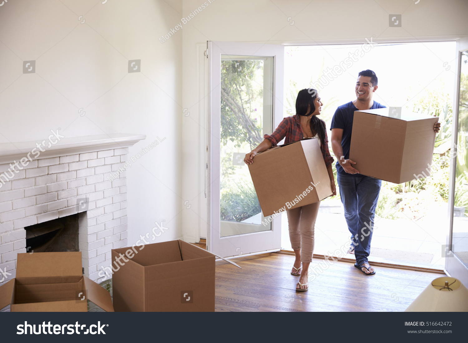 Couple Carrying Boxes Into New Home On Moving Day #516642472