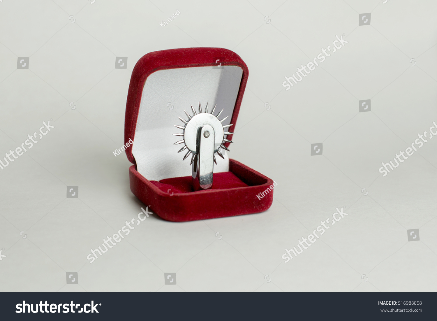 Fake Proposal That Instead Of A Wedding Ring Inserted Wartenberg Wheel Which Is Used In Bdsm Stock Photo Fake Proposal That Instead Of A Wedding Ring Inserted Wartenberg Wheel Which Is Used In Bdsm Stock Photo