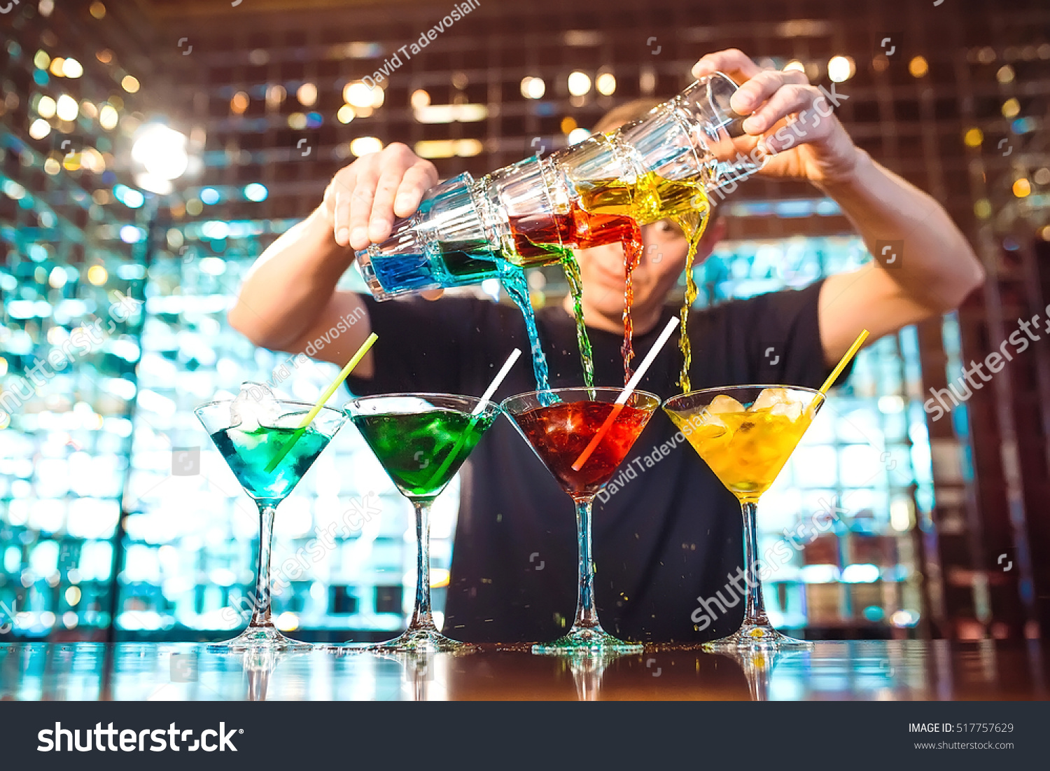 Barman show. Bartender pours alcoholic cocktails. #517757629