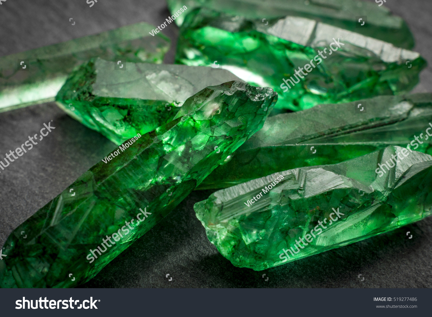 Closeup of a bunch of many green rough uncut emerald crystals #519277486