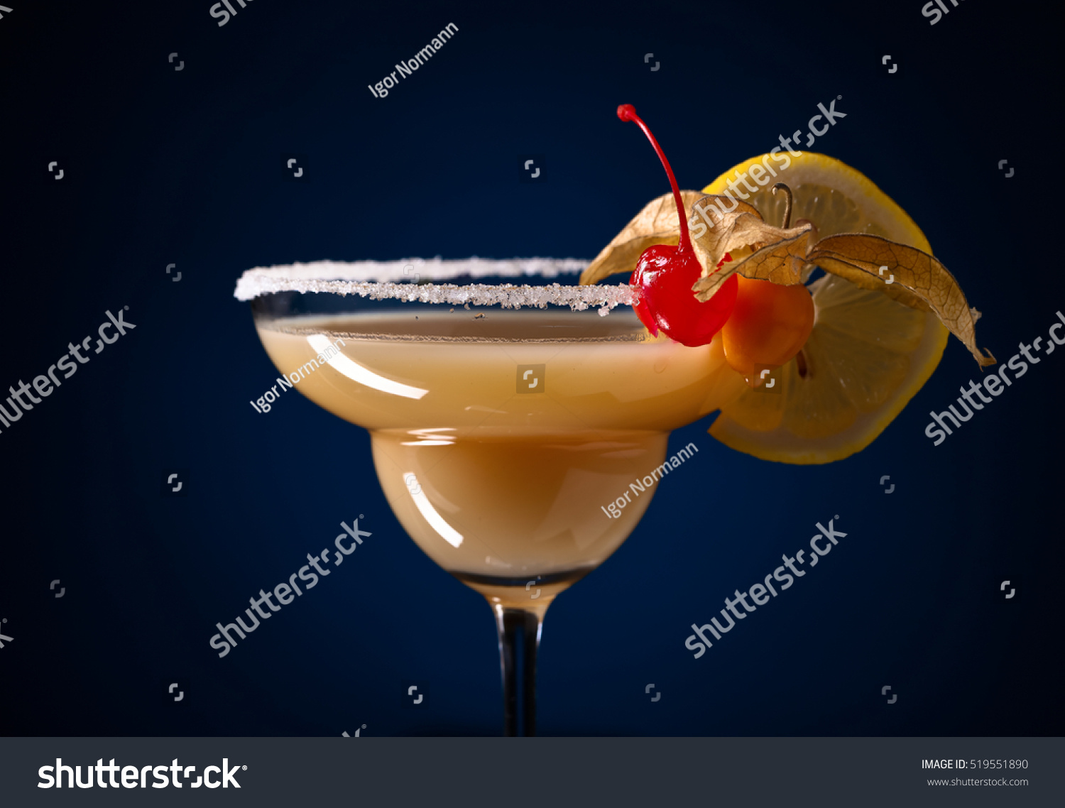 Sweet cocktail with physalis , cherry and lemon  on a dark blue background #519551890