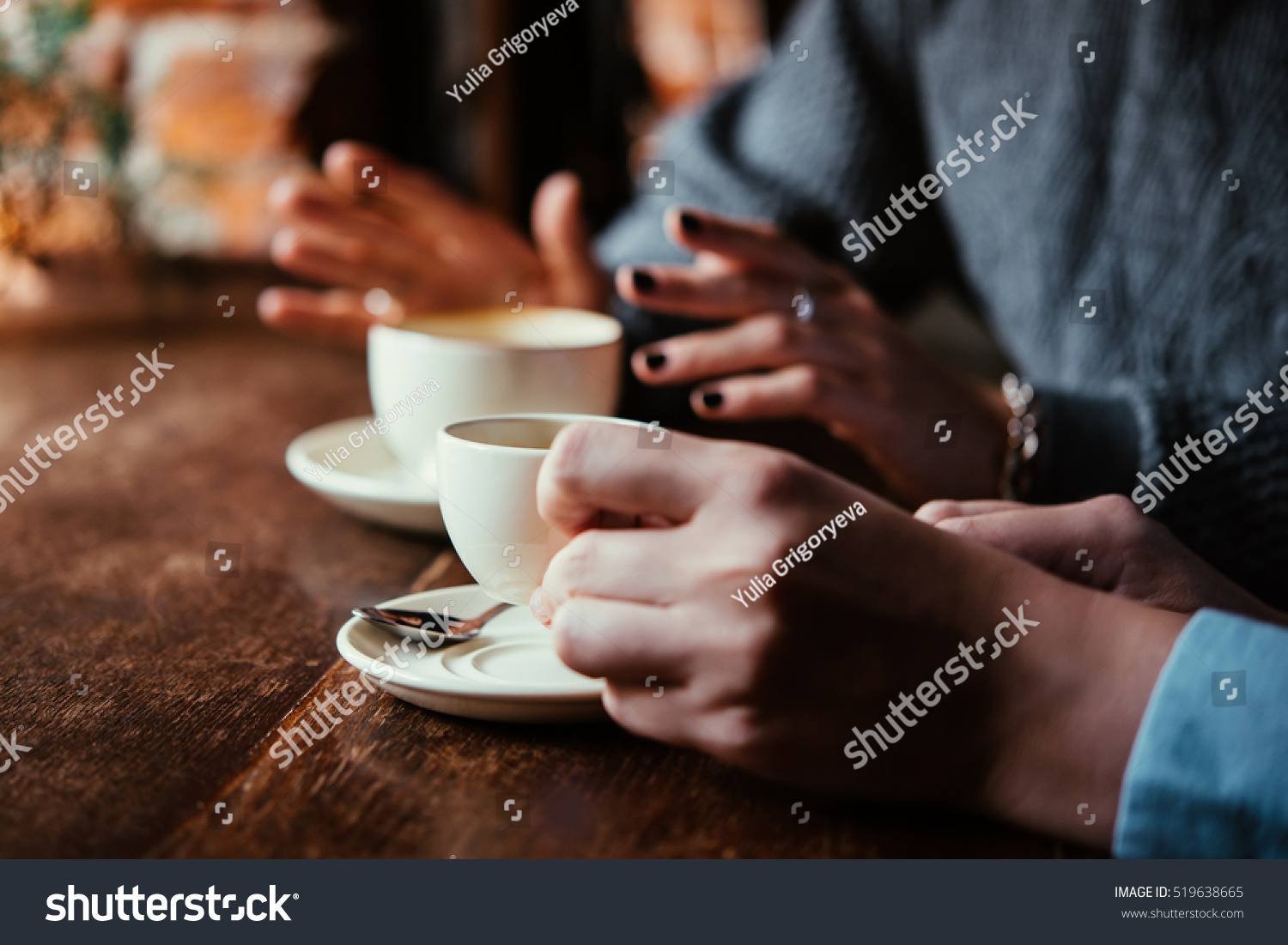 Two women discussing business projects in a cafe while having coffee #519638665