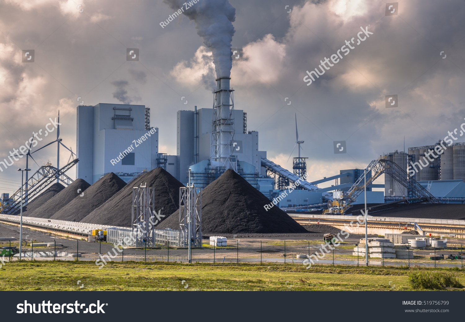 Heavy industrial coal powered electricity plant with pipes and smoke in black and white #519756799