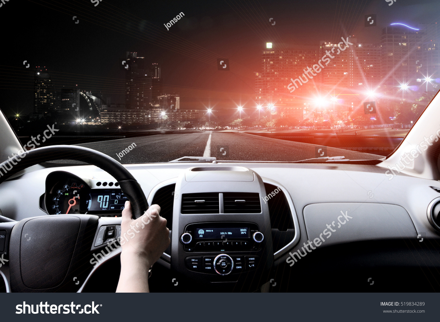 Drivers hands on the steering wheel inside of a car #519834289