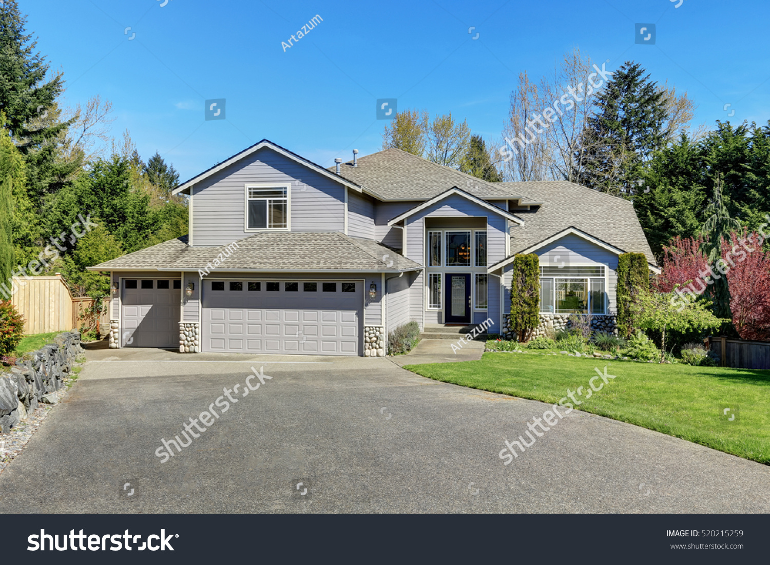 Traditional blue home exterior in Puyallup with wood siding and elegant front door. Northwest, USA #520215259