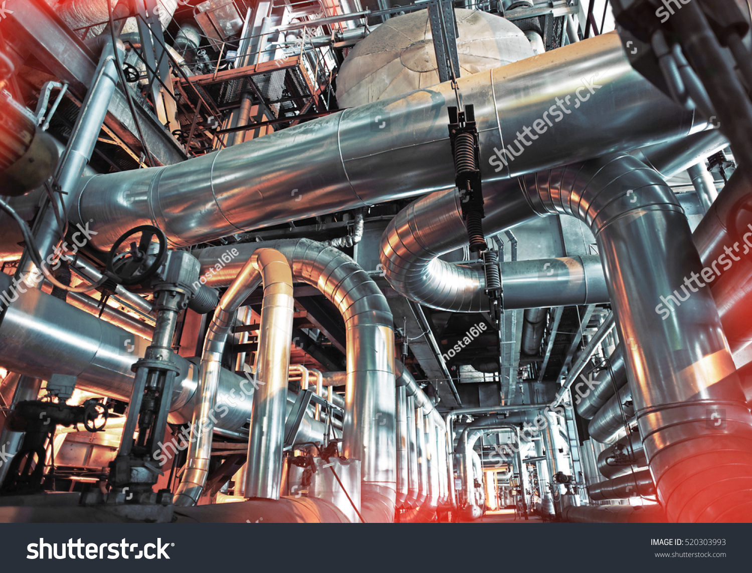 Equipment, cables and piping as found inside of a modern industrial power plant
              #520303993