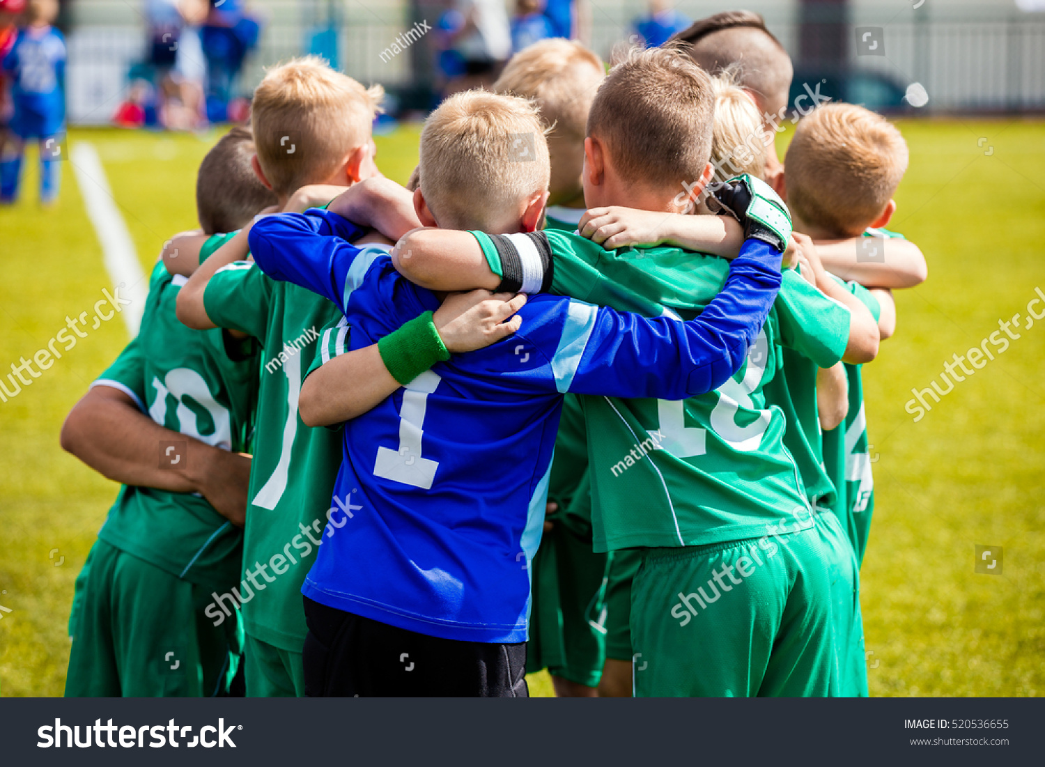 Young football soccer players in sportswear. Young sports team with football coach. Pep talk with coach before the final match. Soccer school tournament #520536655
