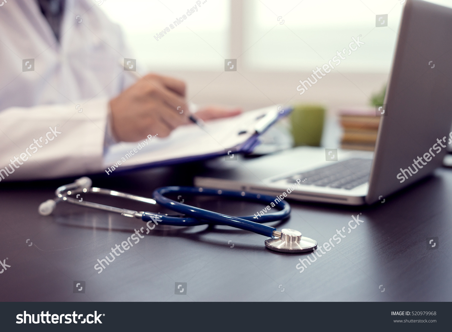 Stethoscope with clipboard and Laptop on desk,Doctor working in hospital writing a prescription, Healthcare and medical concept,test results in background,vintage color,selective focus #520979968