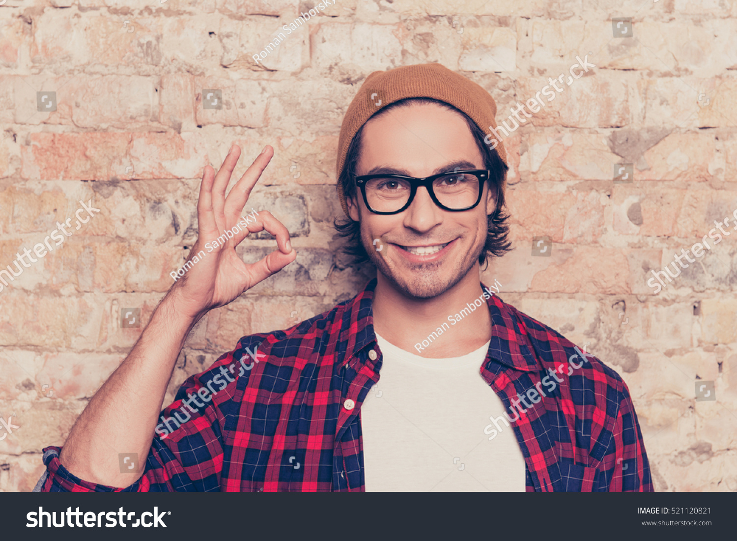 Portrait of cheerful hipster man in glasses gesturing ok #521120821
