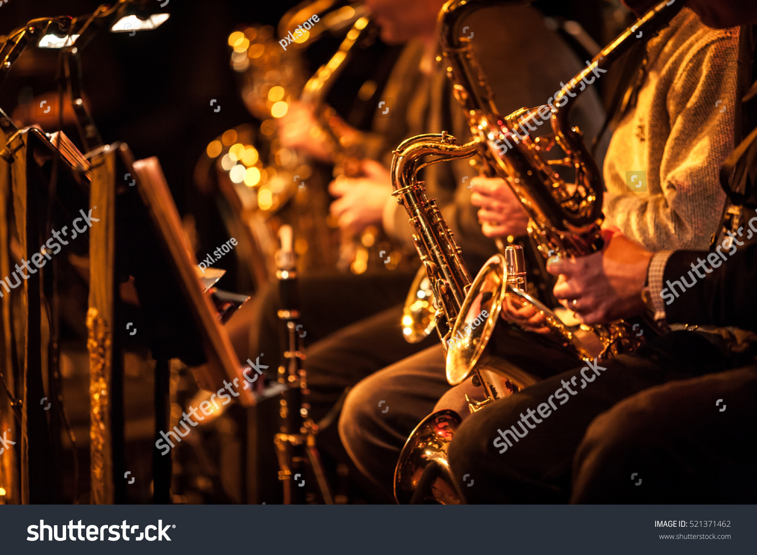 Big Band saxophone section. A candid view along the saxophone section of a big band in concert.
 #521371462