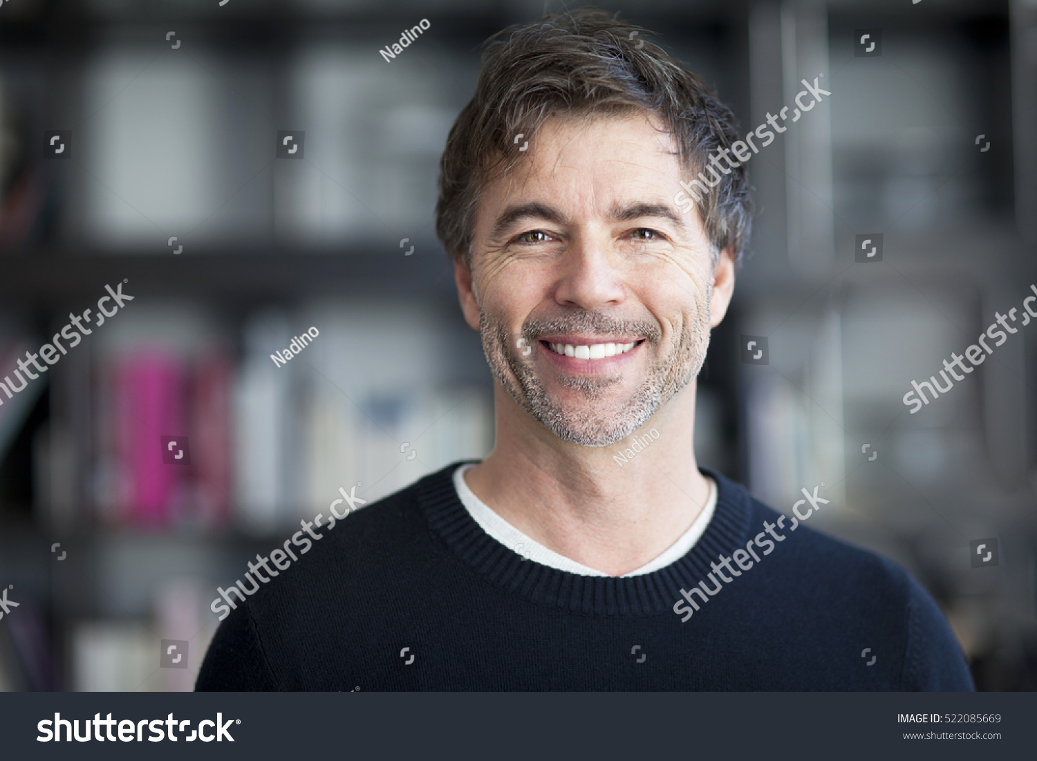 Portrait Of A Mature Man Smiling At The Camera. #522085669