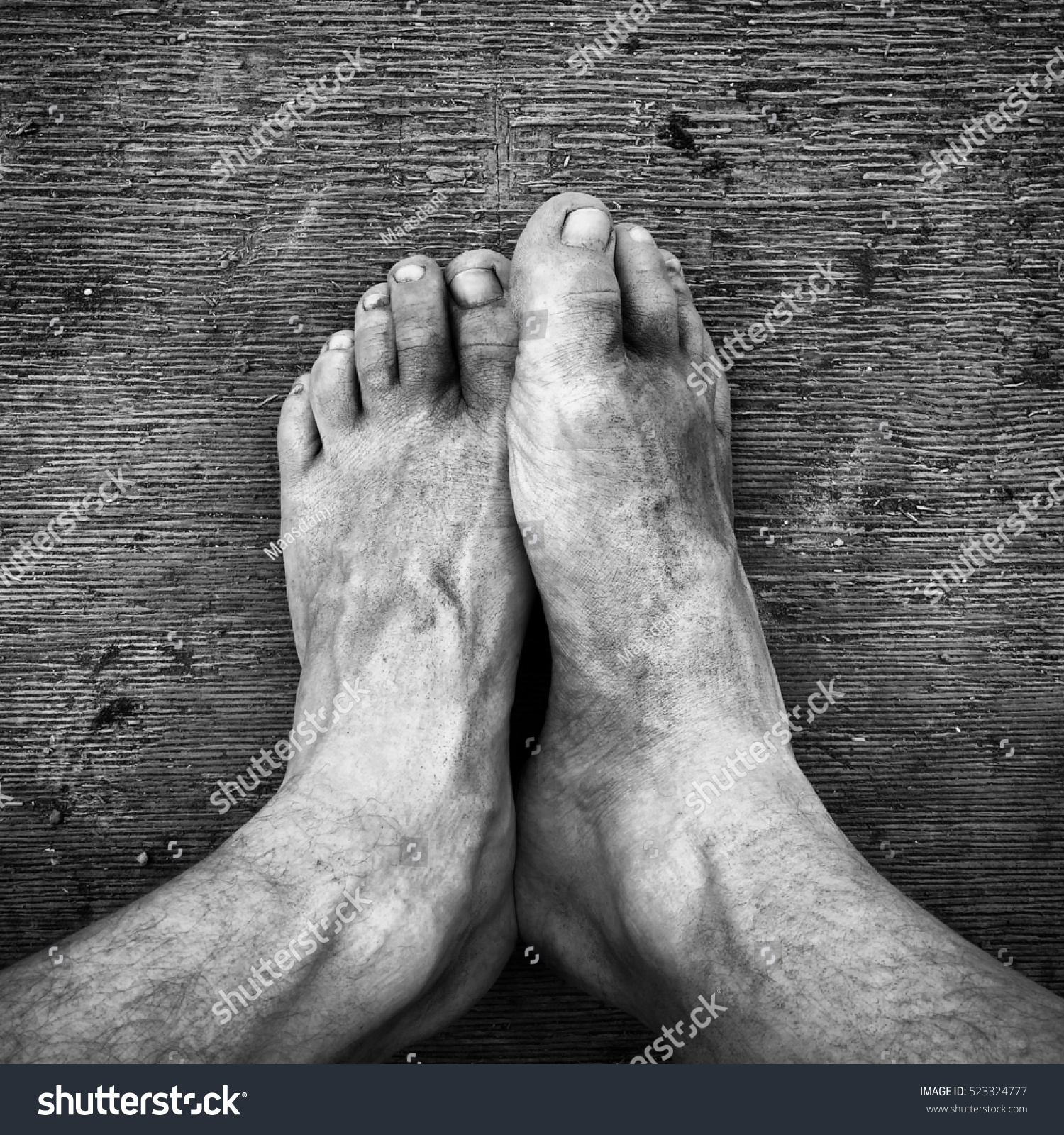 Black and white. Dirty feet on the wooden floor #523324777