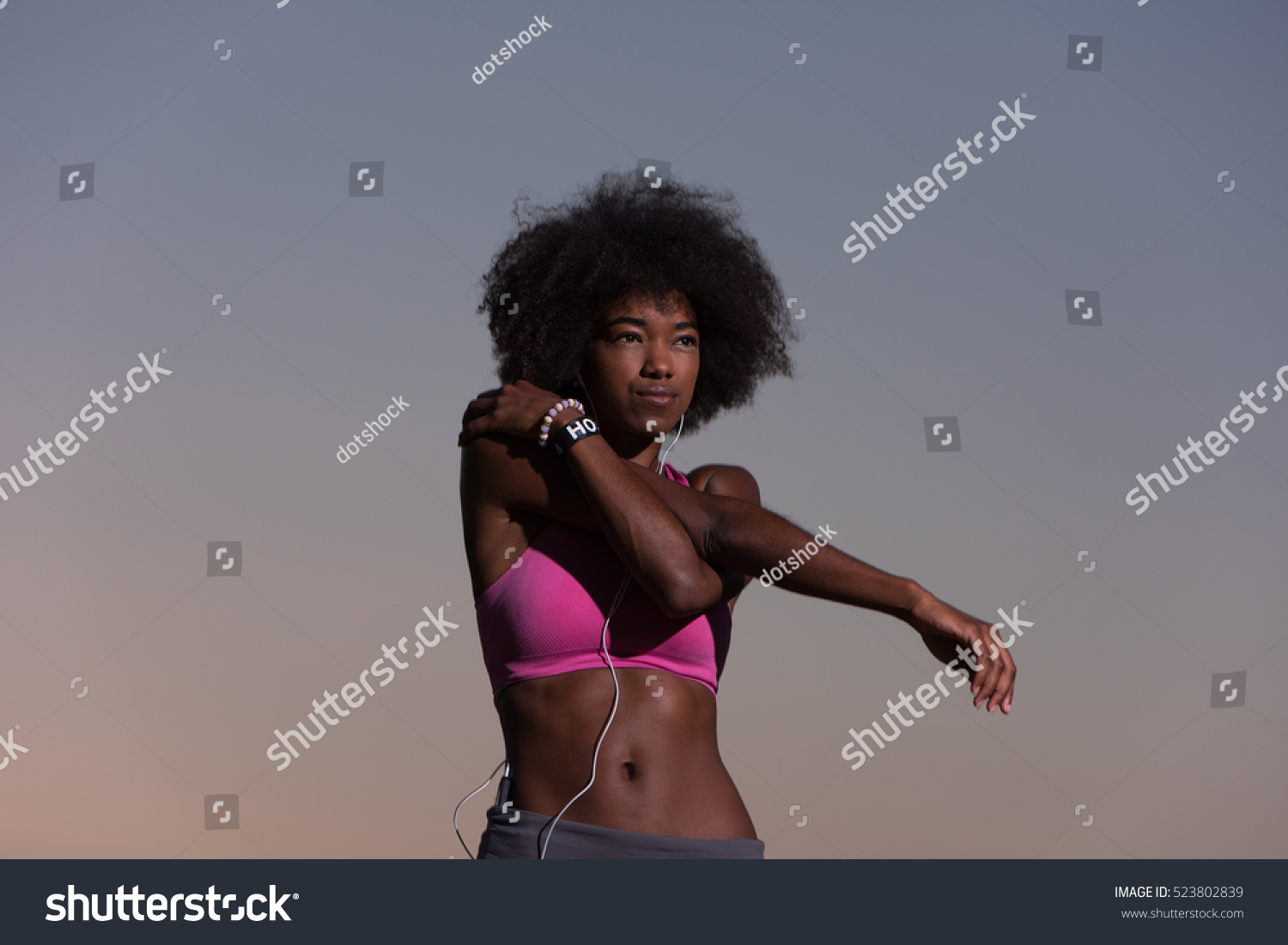 Young healthy black woman is doing stretching exercise relaxing and warm up after jogging and running in the nature beautiful summer evening #523802839