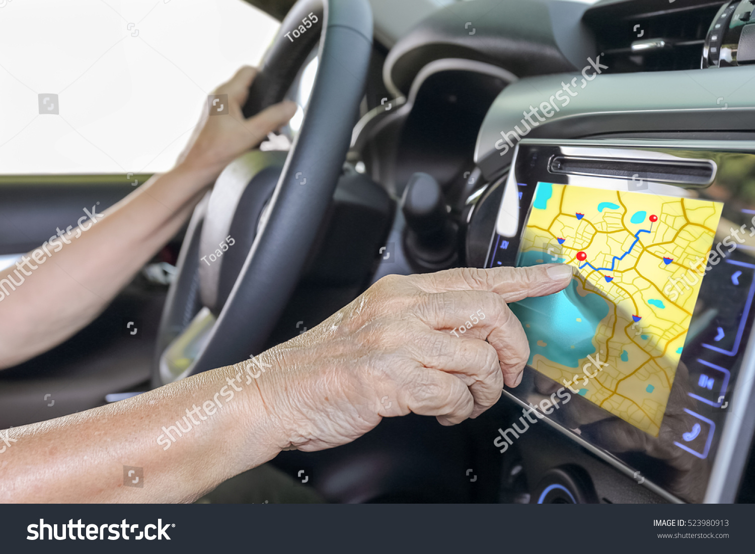 Elderly woman using GPS navigation system in car  #523980913