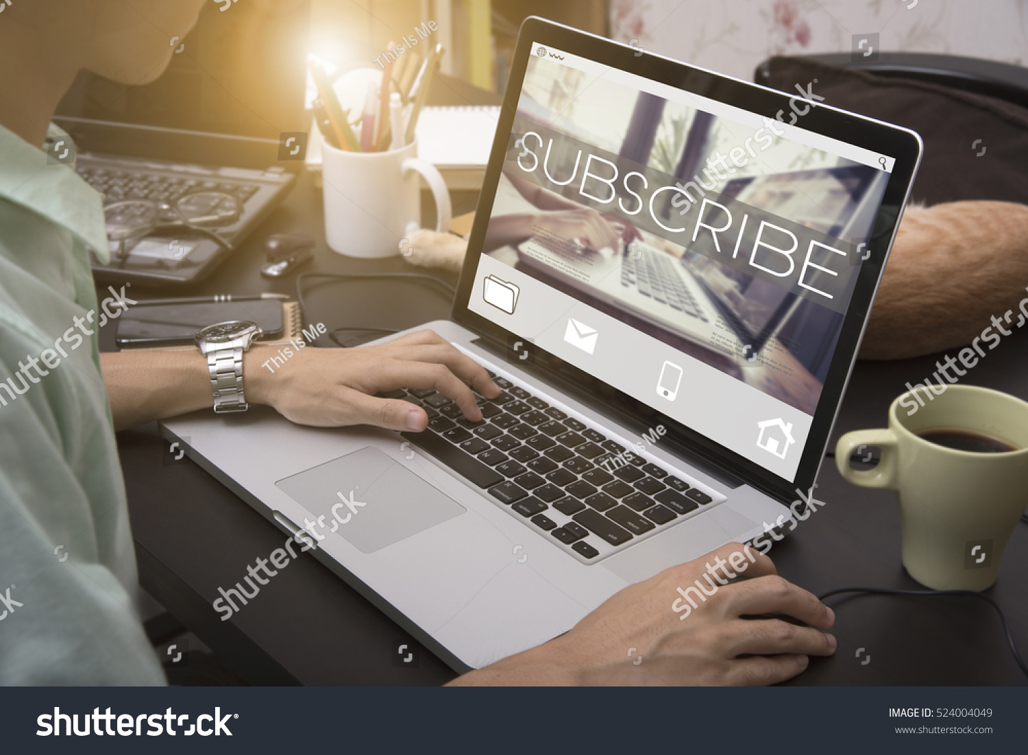 business hand typing on a laptop keyboard with Subscribe homepage on the computer screen follow subscription membership social media concept. #524004049