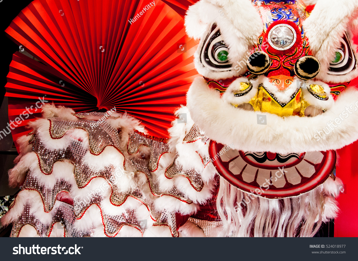 Chinese lion dance for Chinese new year with red fan in the background #524018977