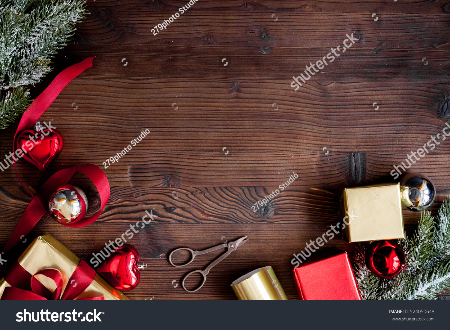 packaging christmas gifts in boxes on wooden background top view #524050648