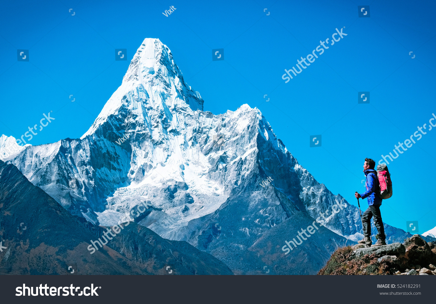 Hiker with backpacks reaches the summit of mountain peak. Success, freedom and happiness, achievement in mountains. Active sport concept. #524182291