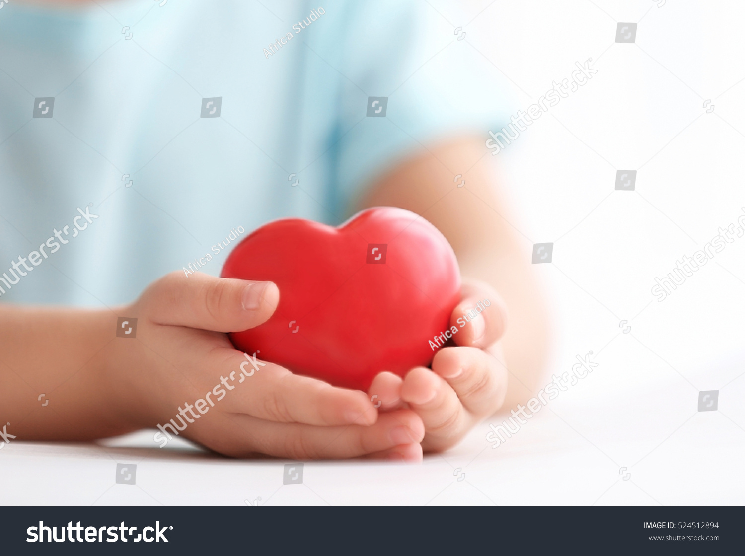 Little girl holding heart in her hands #524512894