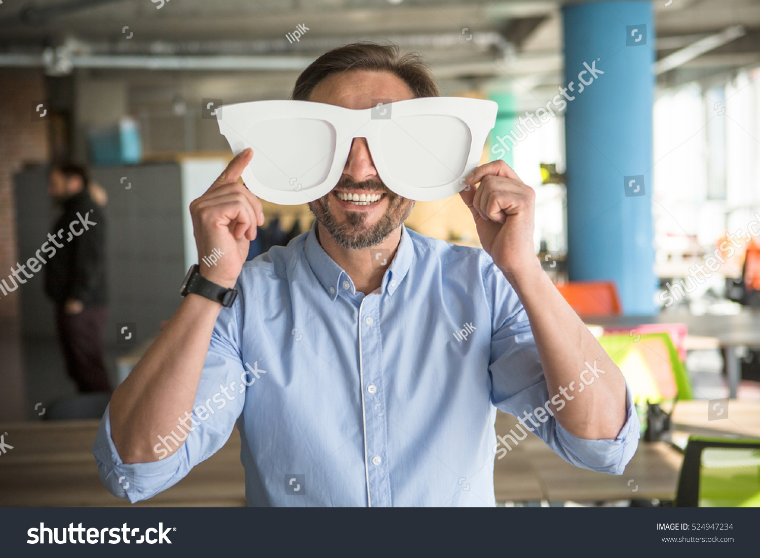 Happy businessman with funny glasses on showing to camera. Handsome happy man joking during work. Break time concept. #524947234