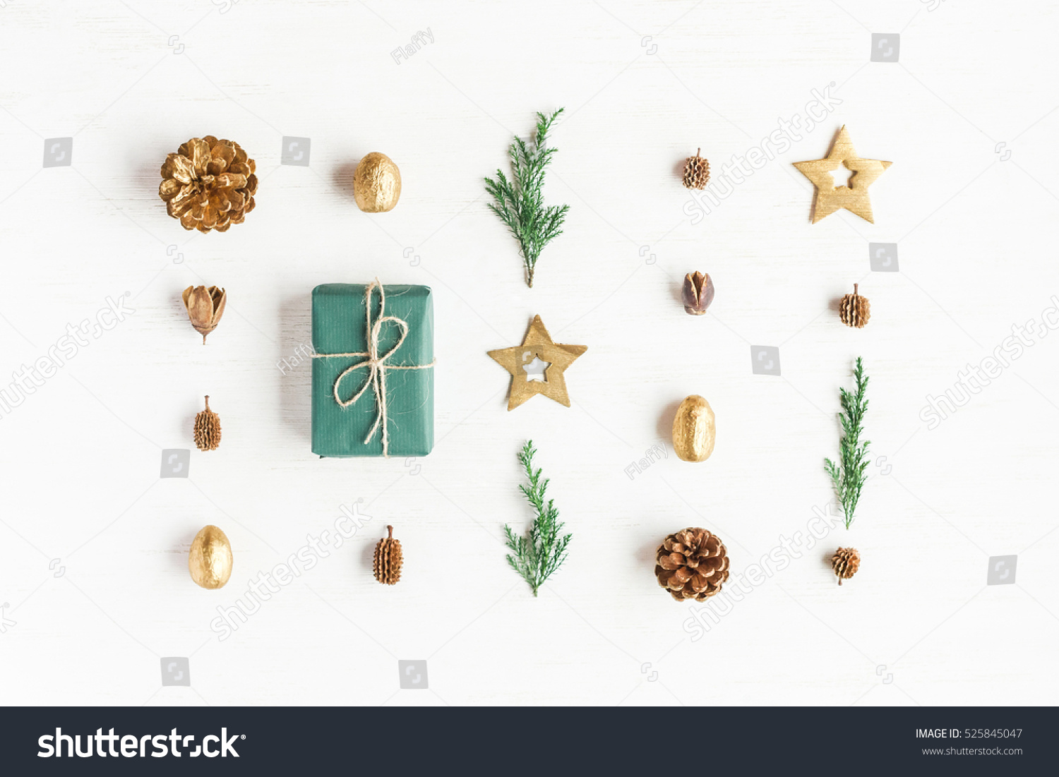 Christmas composition. Gift, christmas golden decorations, cypress branches, pine cones on white background. Flat lay, top view #525845047