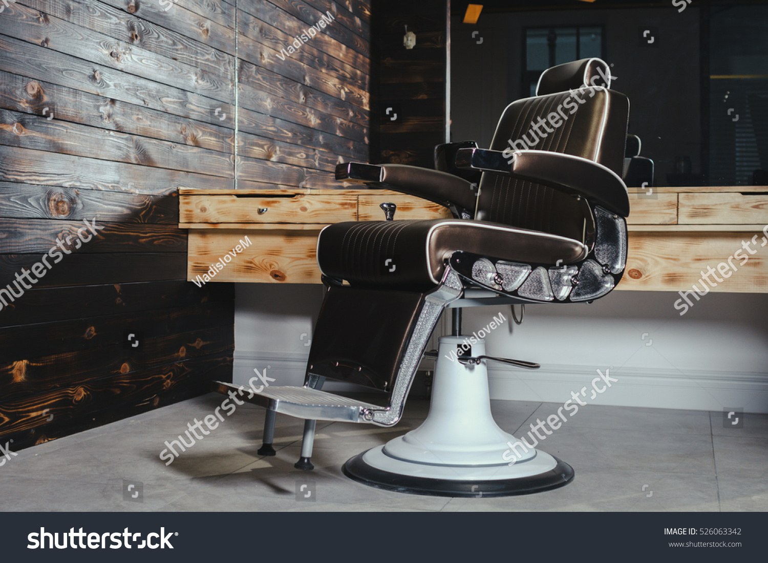 Stylish Vintage Barber Chair In Wooden Interior. Barbershop Theme #526063342