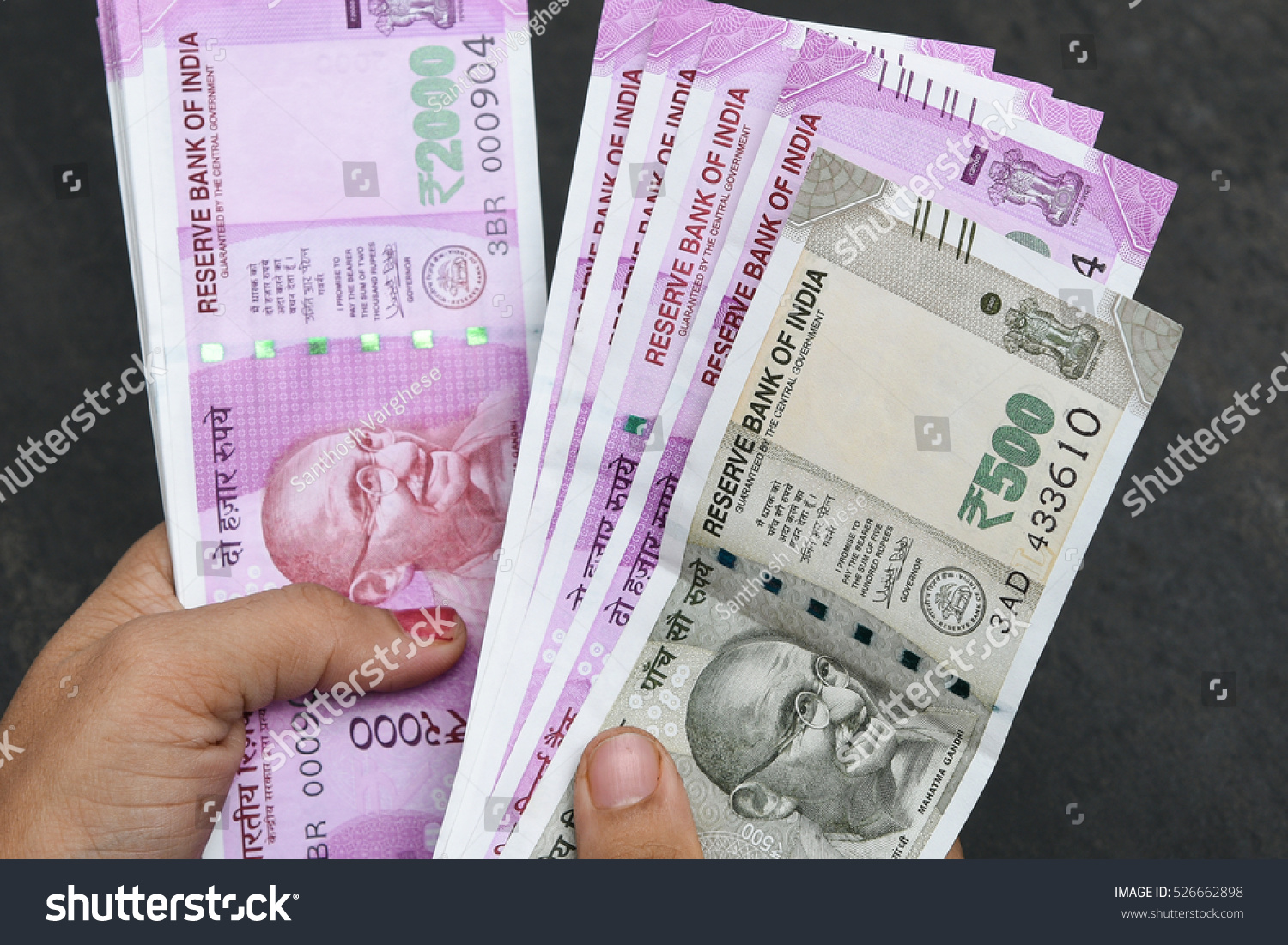 2000 and 500 rupee banknote India,The brand new Indian currency notes of 2000 and 500 rupees isolated on black. Business woman holding counting money. Success and got profit from business #526662898