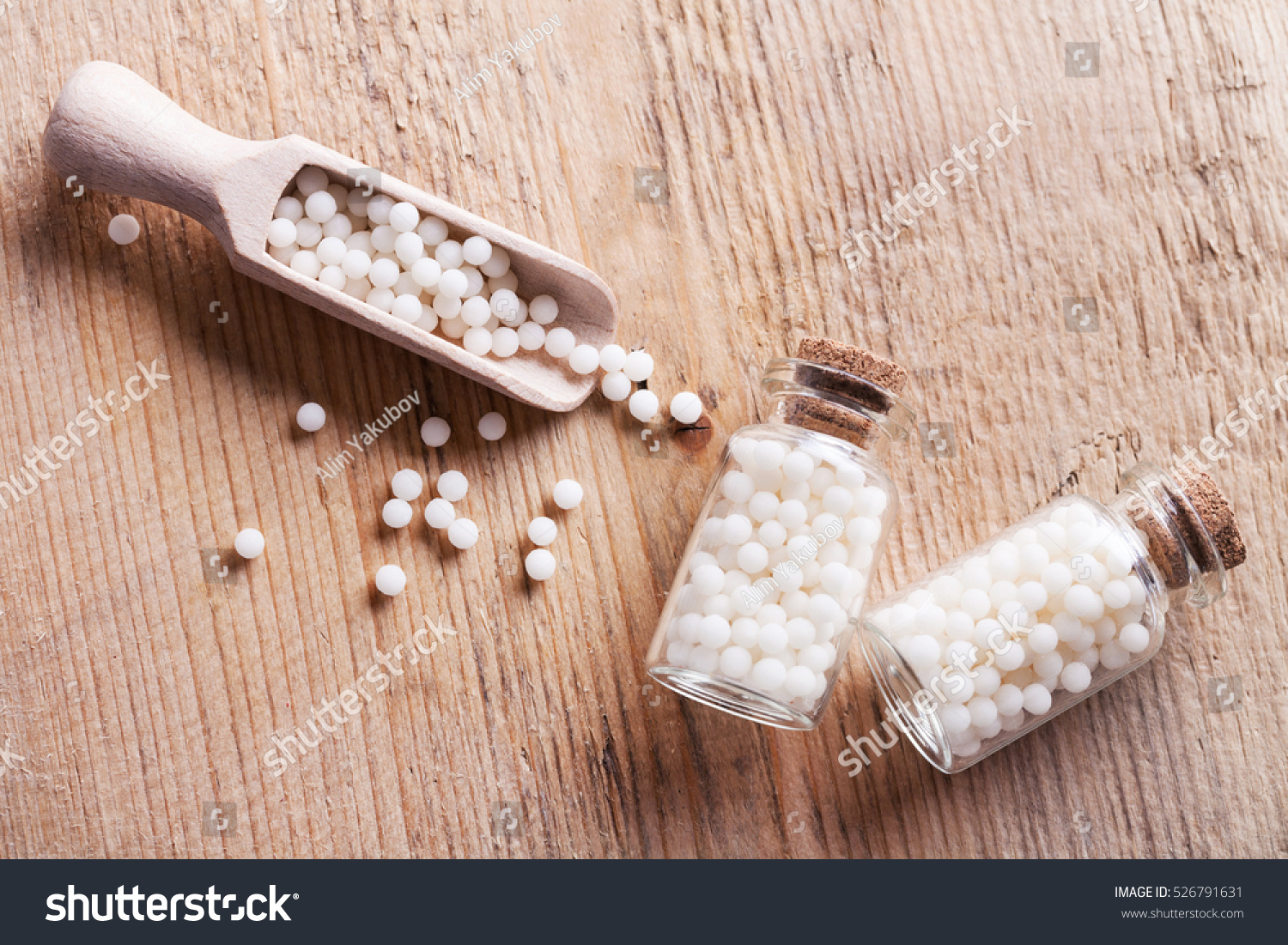 Closeup image of homeopathic medicine consisting of the pills and a bottle containing a liquid homeopathic substance.
 #526791631