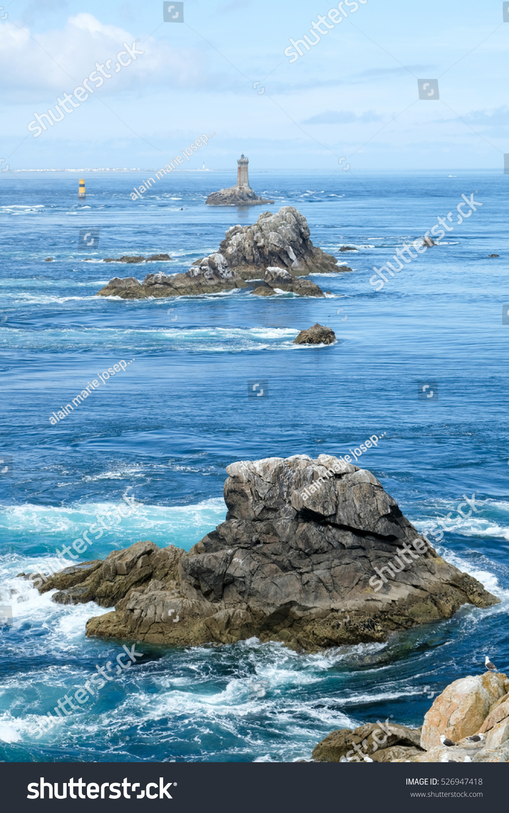 Coast in Brittany, with cliffs at the top of cliffs, Rocky promontory Pointe du Raz #526947418