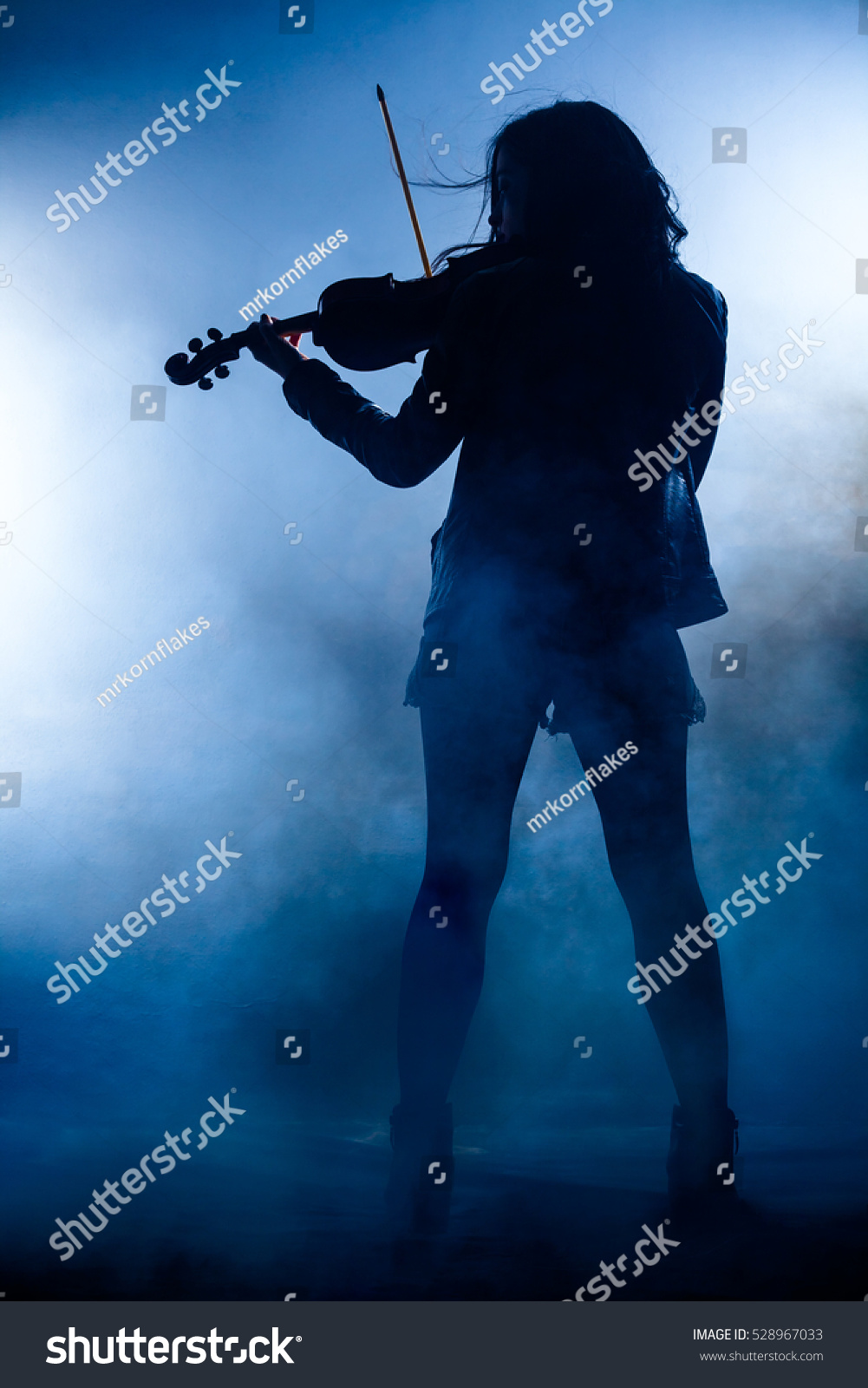 Silhouette of a Rock Woman with Leather Jacket Playing a Violin #528967033