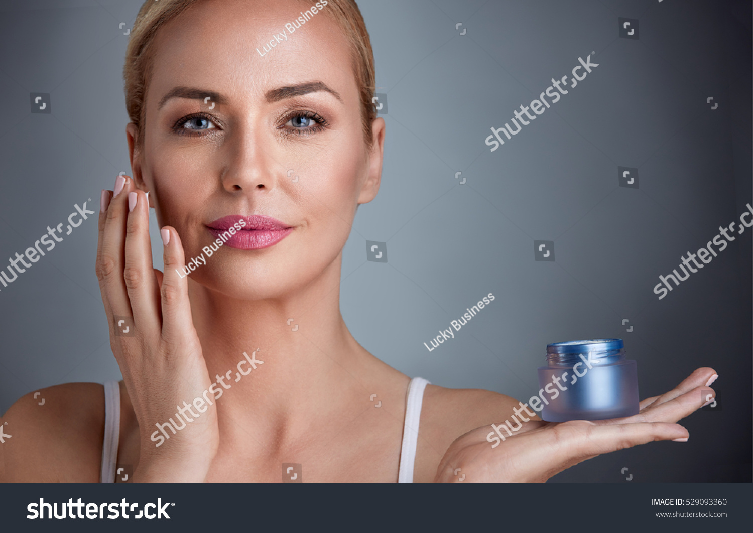 
Beautiful nourished woman holding cream for her skin  #529093360
