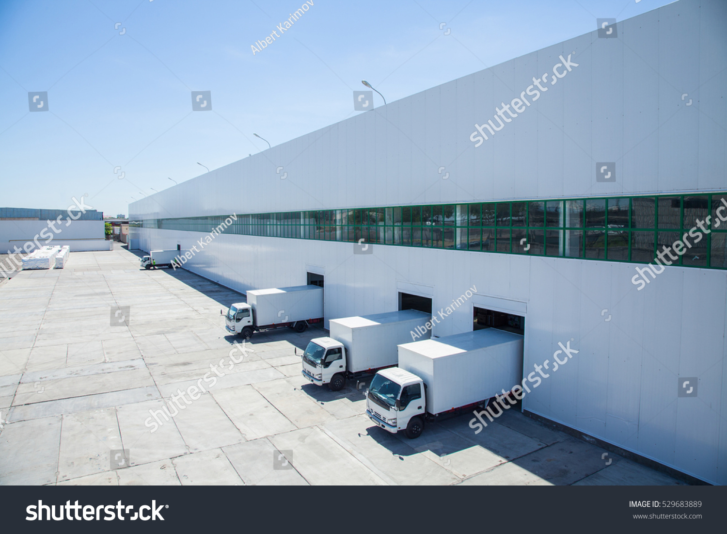 facade of an industrial building and warehouse with freight cars in length #529683889