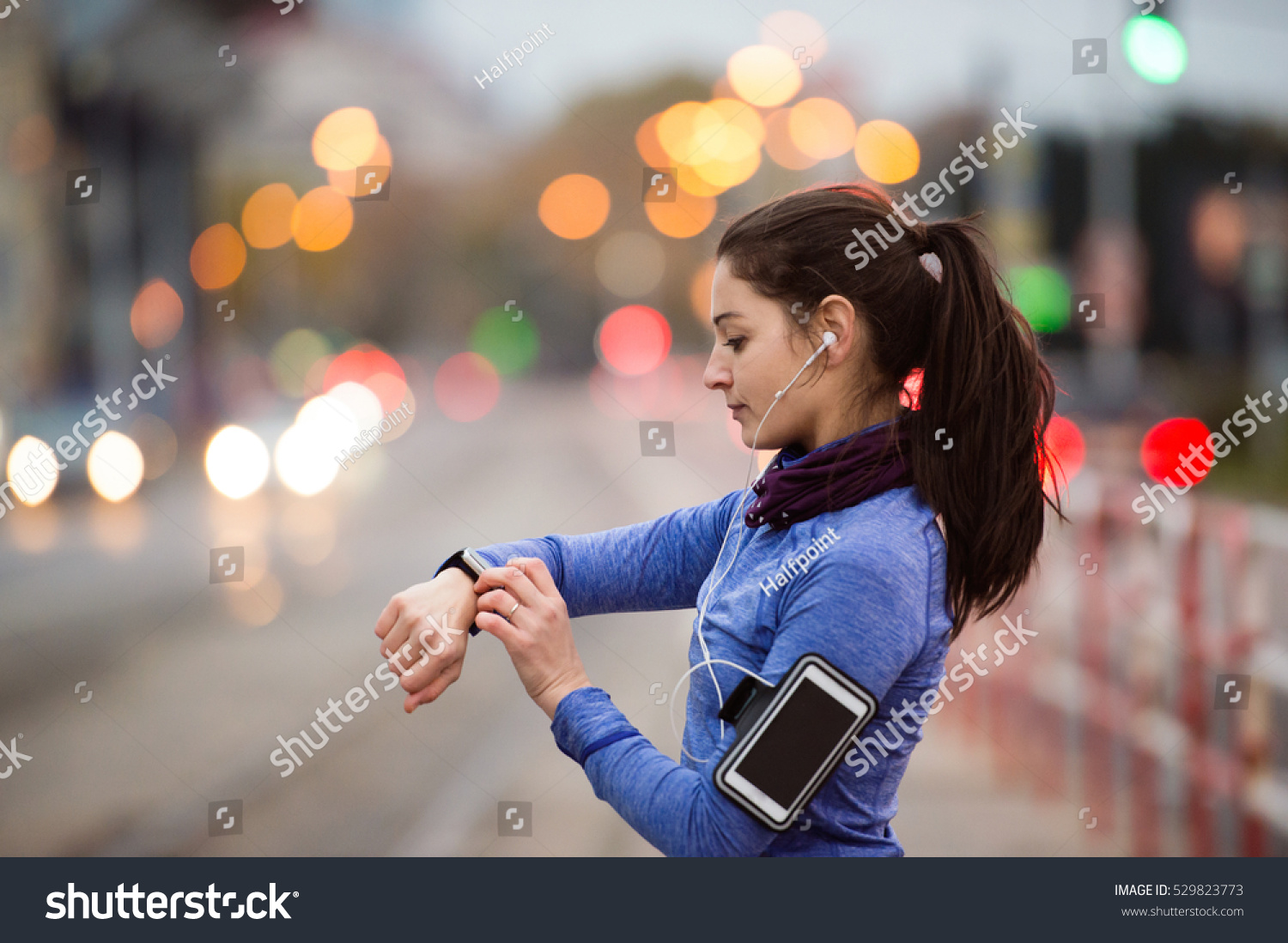 Young woman in blue sweatshirt running in the city #529823773
