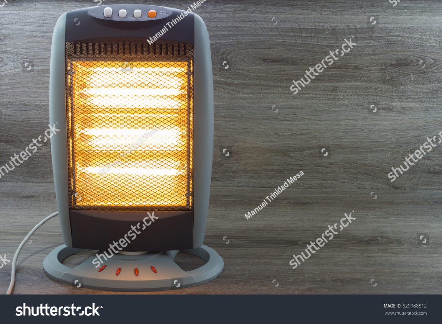 Halogen Electric Stove illuminated and radiating on gray background #529988512
