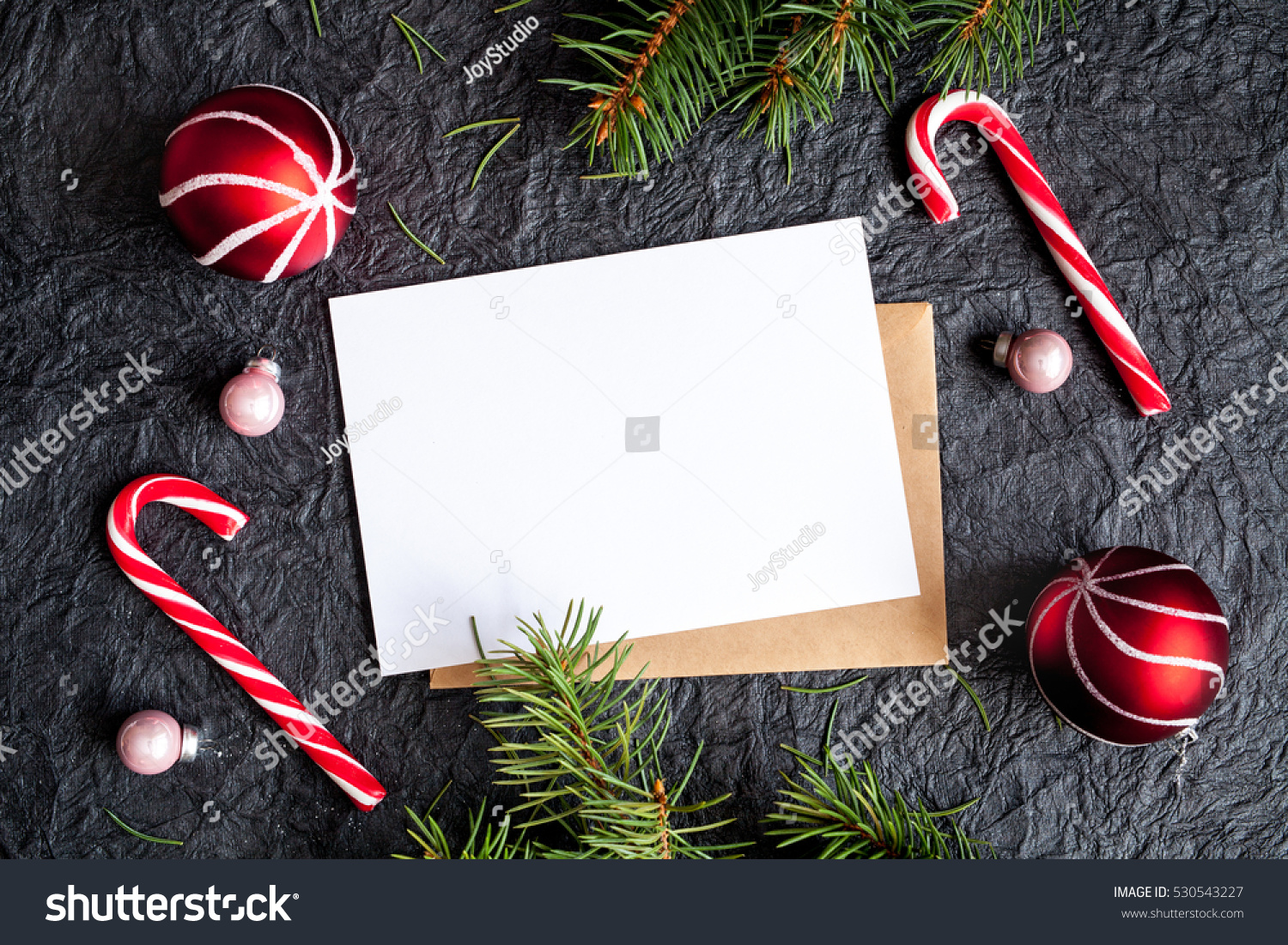 Dark christmas background with christmas decoration, christmas balls and christmas candy cane #530543227