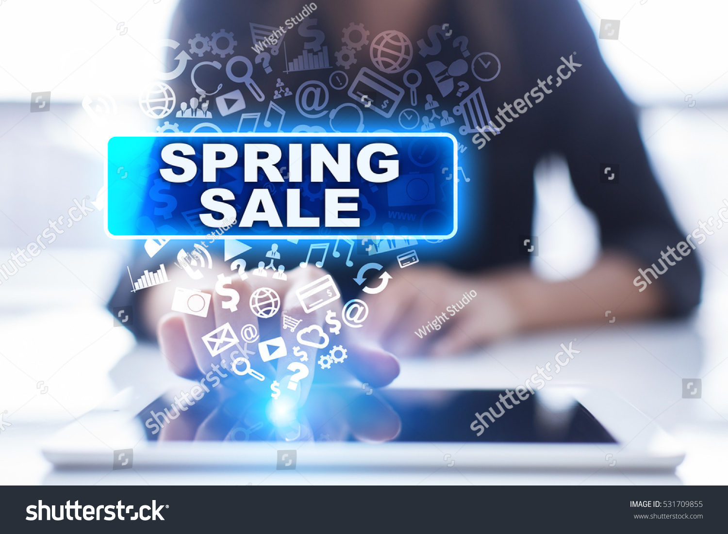 Woman is using tablet pc, pressing on virtual screen and selecting spring sale. #531709855