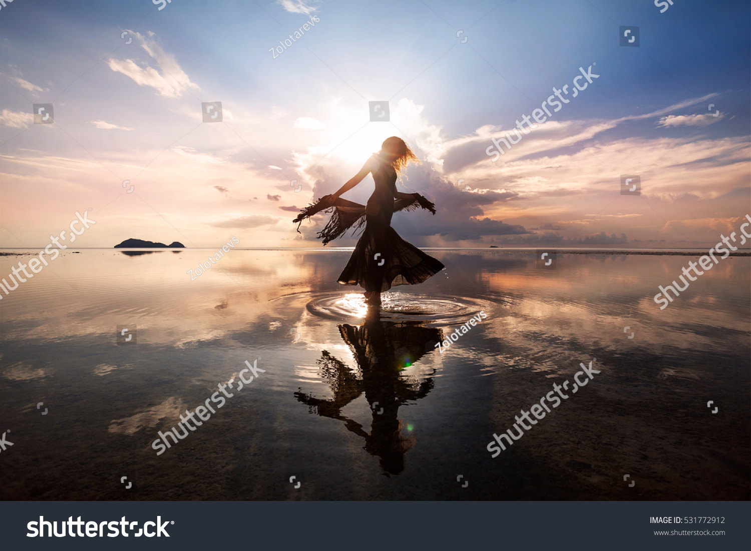 Elegant woman dancing on water. Sunset and silhouette. #531772912