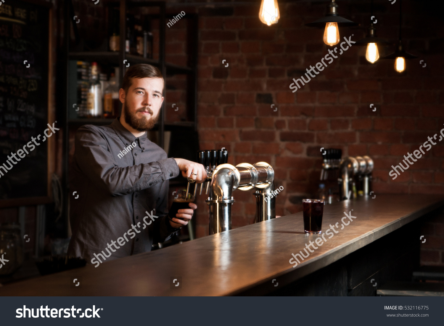 Attractive bartender is pouring a beer #532116775