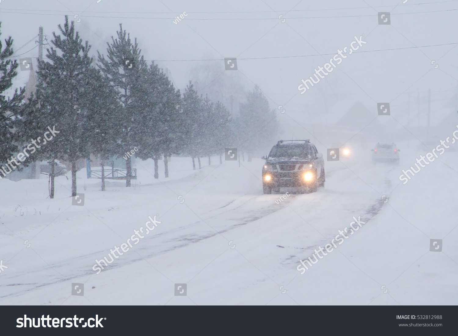 Winter, snow, Blizzard, poor visibility on the road. Car during a Blizzard on the road with the headlights.

 #532812988