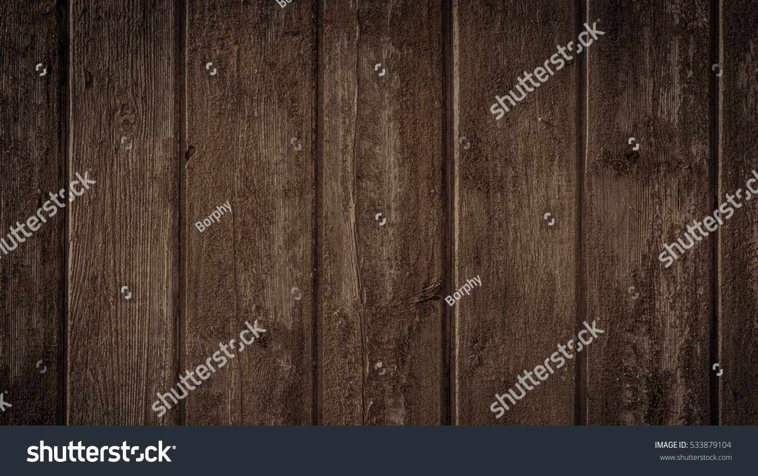 Old rural wooden wall in dark brown colors, detailed plank photo texture. Natural wooden building structure background. #533879104