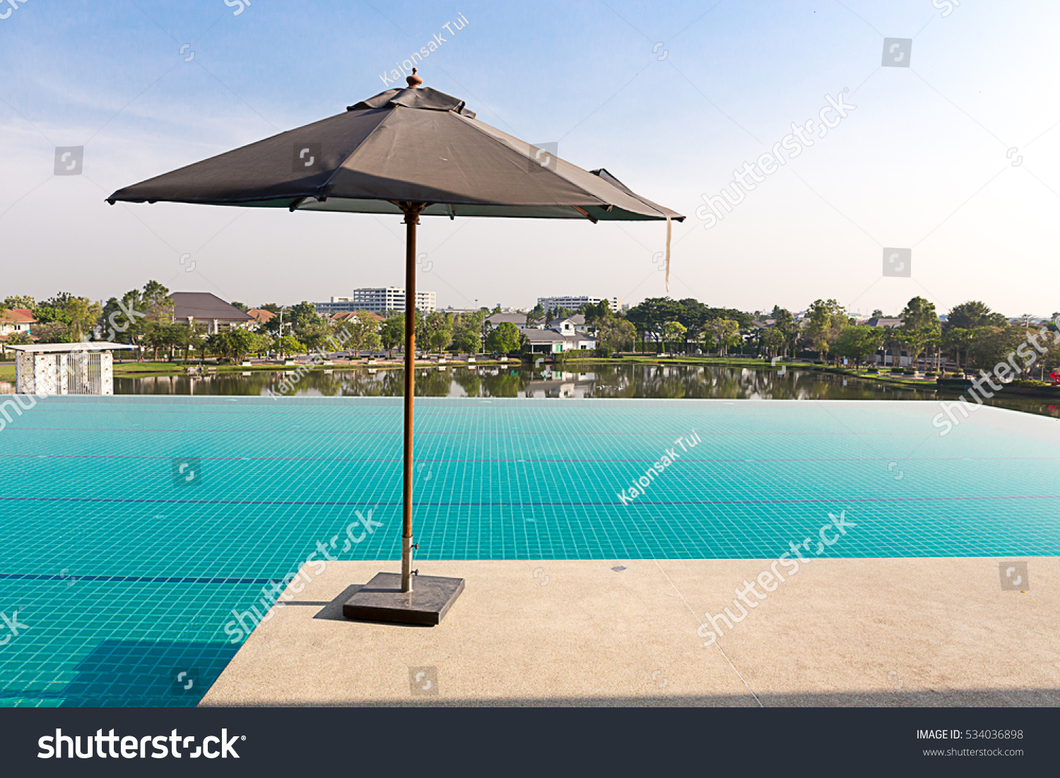 Umbrella service in upper deck swimming pool in luxury village with beautiful sky at morning. #534036898