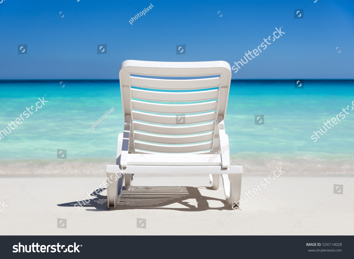 Sunbeds on tropical sandy beach. Vacation on the sea
 #534114028