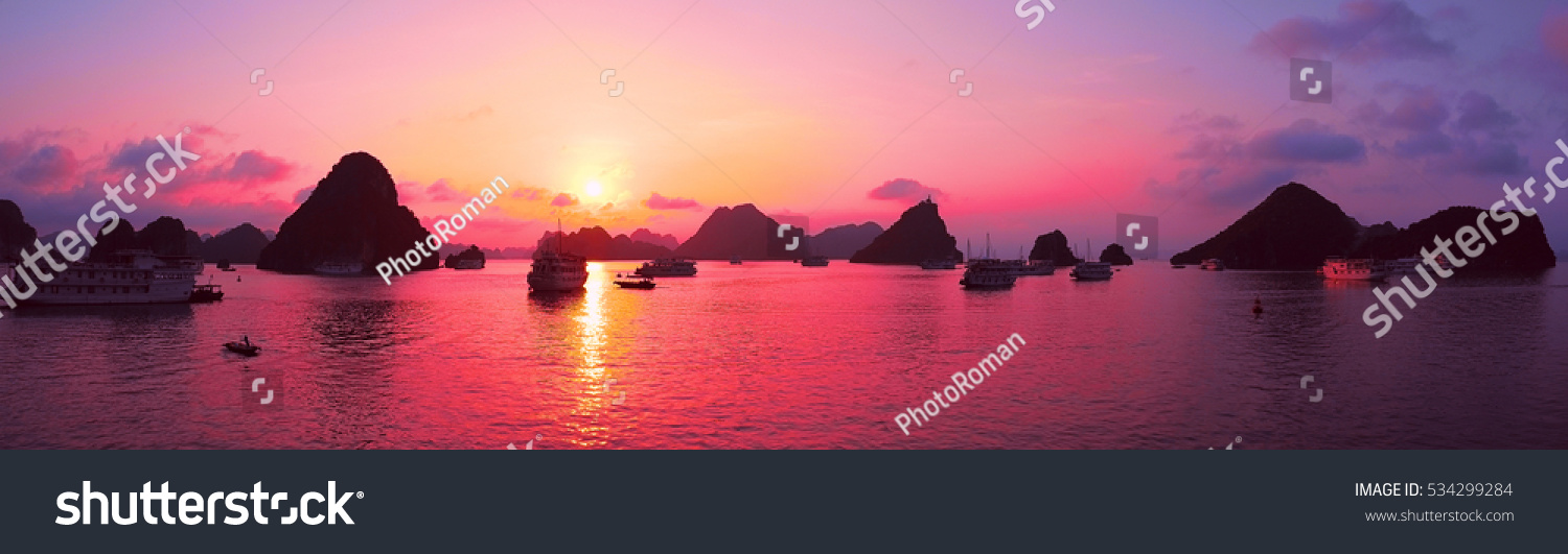Beautiful purple sunset and rock islands in Halong Bay Vietnam Southeast Asia. Panorama. Junk boat cruise to Ha Long Bay. Exotic scenery. Panoramic view. Landscape Pink sky. Famous landmark of Vietnam #534299284